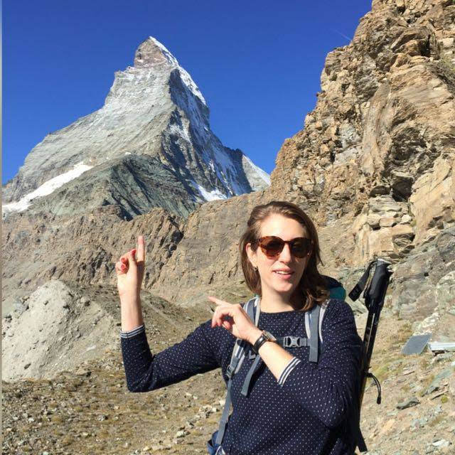 Corina Burri with hiking poles in front of the Matterhorn